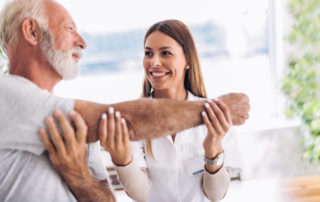 senior man with nurse stretching