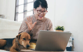 Oakleigh of Macomb Senior Living Senior woman video call with family and dog