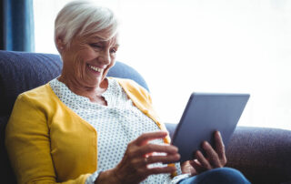 Senior woman looking at digital tablet in hands