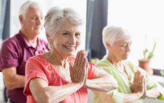 Three seniors at assisted living in Macomb County doing yoga together