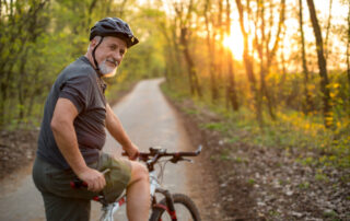 A senior man getting ready to go on a fall bike ride in the park