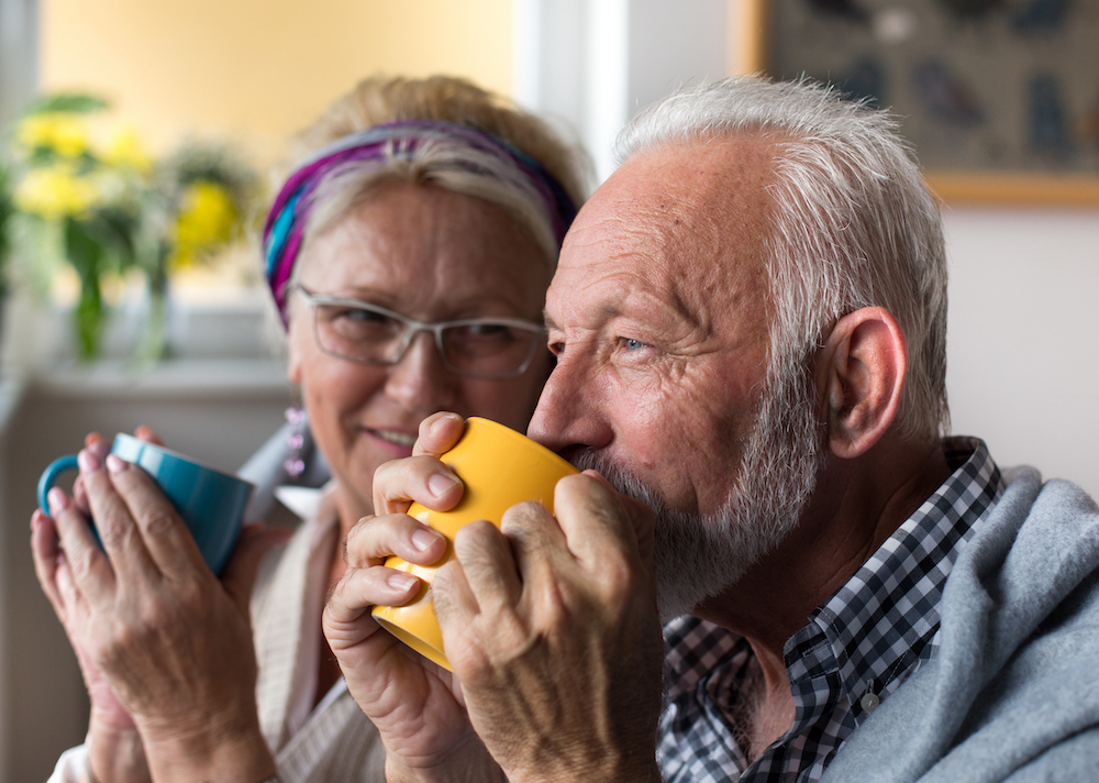A senior couple enjoys a cup of coffee together at the best assisted living in Michigan