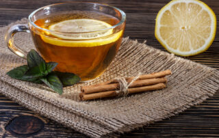 A mug of herbal tea with lemon sitting on a table