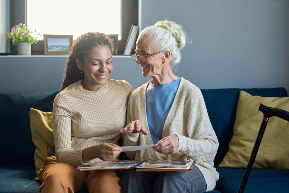 Senior and loved one looking at old photos together 