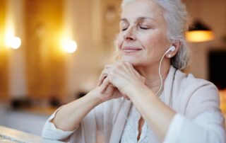 A senior woman listening to music in assisted living facilities near me.