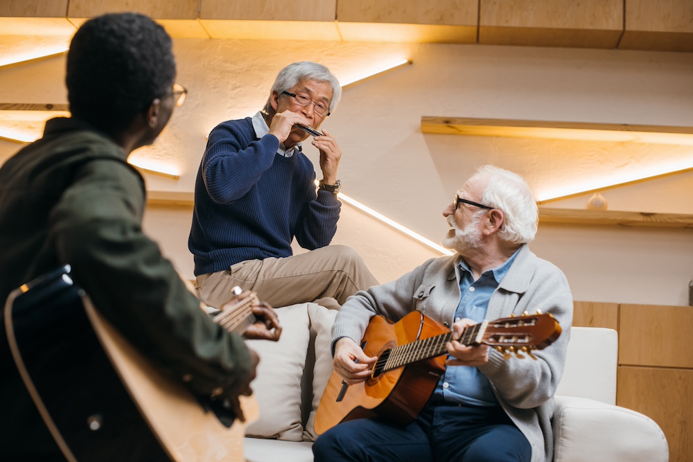 A group of friends playing music with friends at the senior living apartments in Macomb