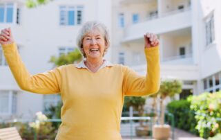 Happy senior woman outside enjoying Senior Assisted Living