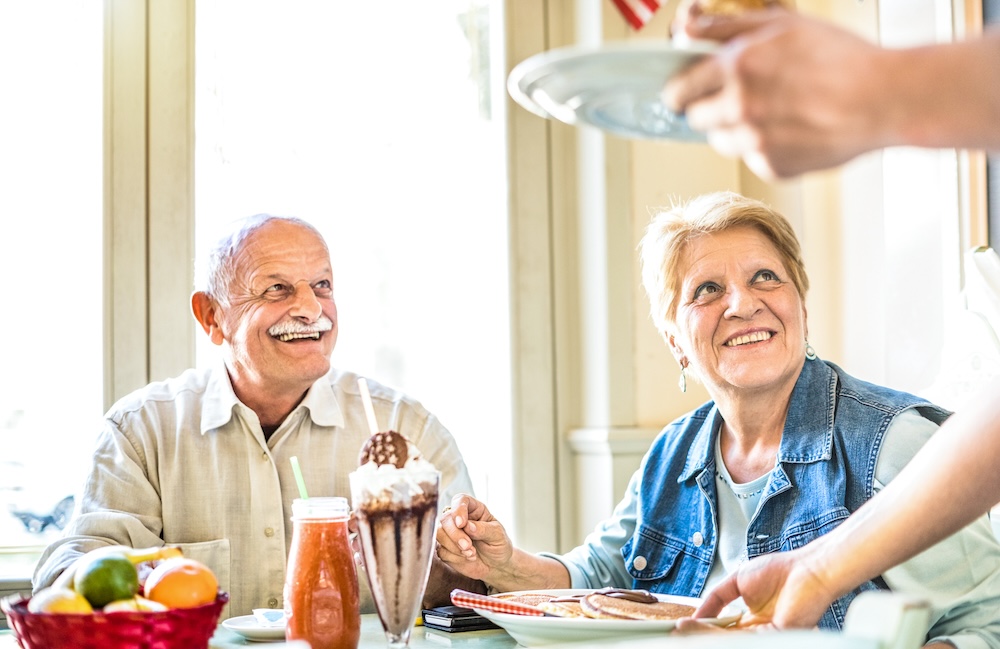 Senior couple enjoying the dining service at their senior living communities in macomb